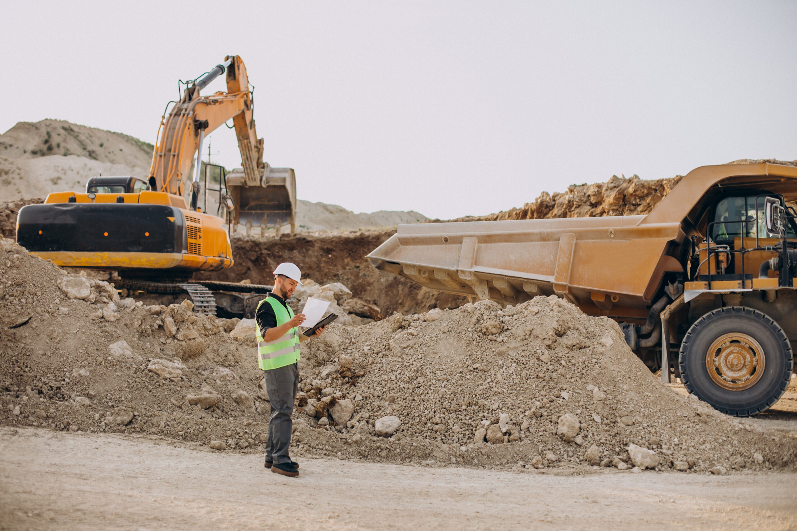 male worker with bulldozer sand quarry scaled